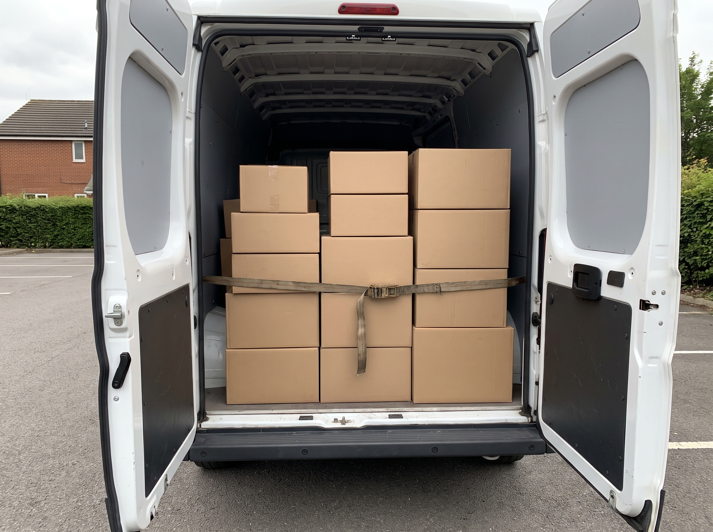 Parcels stacked and strapped in the back of a van